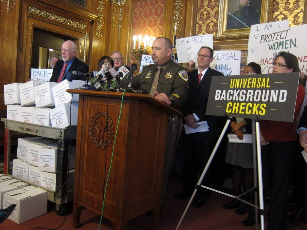 Dane County Sheriff Dave Mahoney speaks at a state capitol press conference as advocates deliver 16-thousand petitions in favor of universal background checks for firearms.