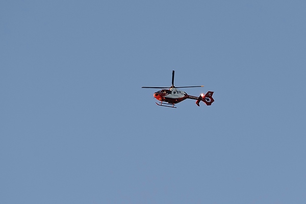 A UW Med Flight helicopter flies above the University of Wisconsin-Madison campus during sunset on Sept. 13, 2013.