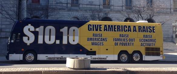 A bus emblazoned with slogans advocating for a higher minimum wage