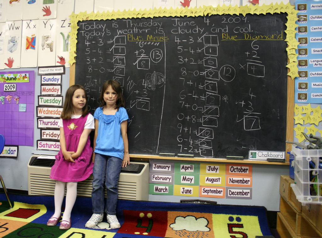 students in front of a chalkboard, math problems