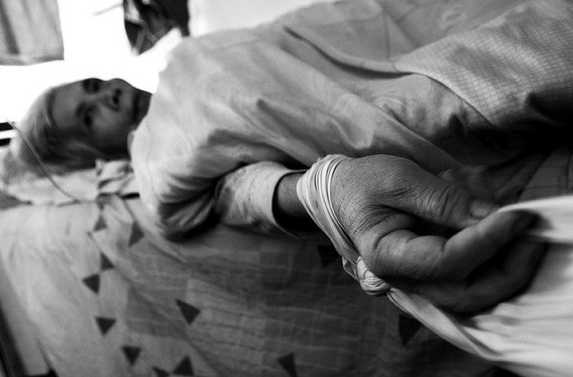 elderly woman in nursing home bed