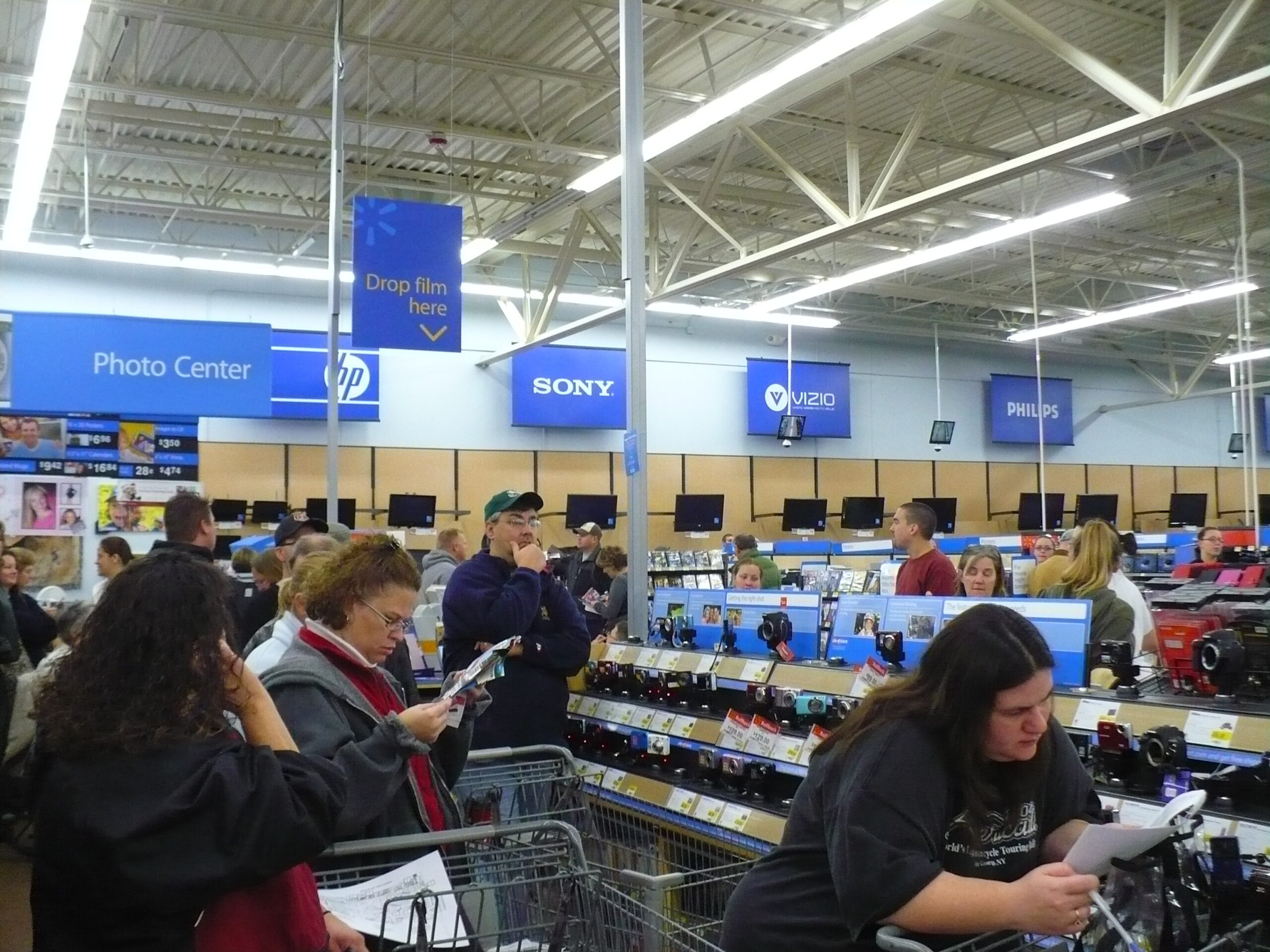People shopping for electronics at Walmart