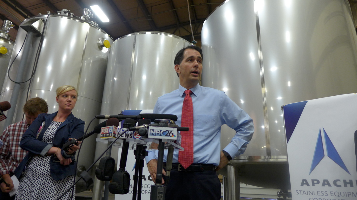 Governor Scott Walker speaks to reporters at Apache Stainless Equipment Corporation in Beaver Dam, Wisconsin.