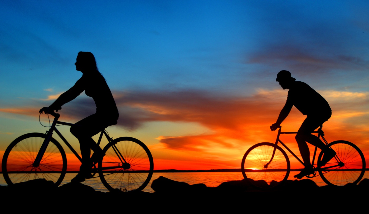 image of bikes along the breakwater riding at sunset