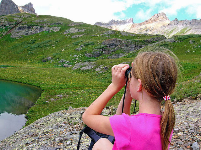 girl with binoculars looking at nature