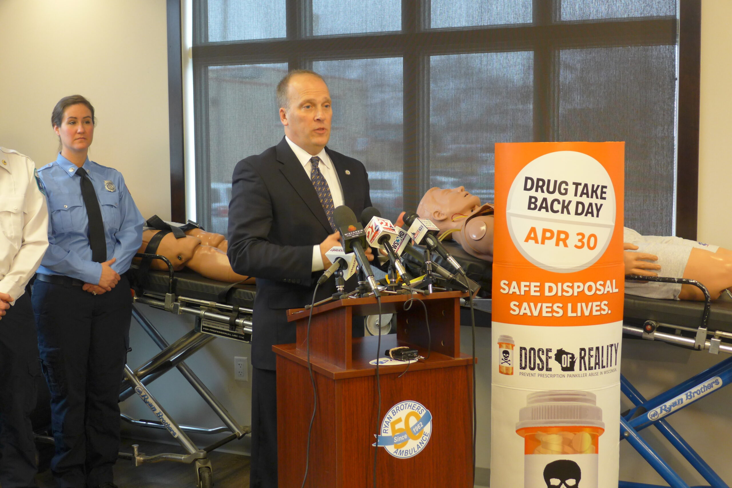 Attorney General Brad Schimel announcing the rebate program with Amphastar Pharmaceuticals for buying pre-filled Naloxone syringes for Abmulance EMT’s to use in revving people who have suffered  a heroin overdose.