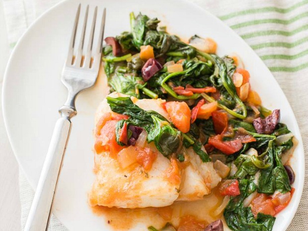 A photo of a fish and spinach dish