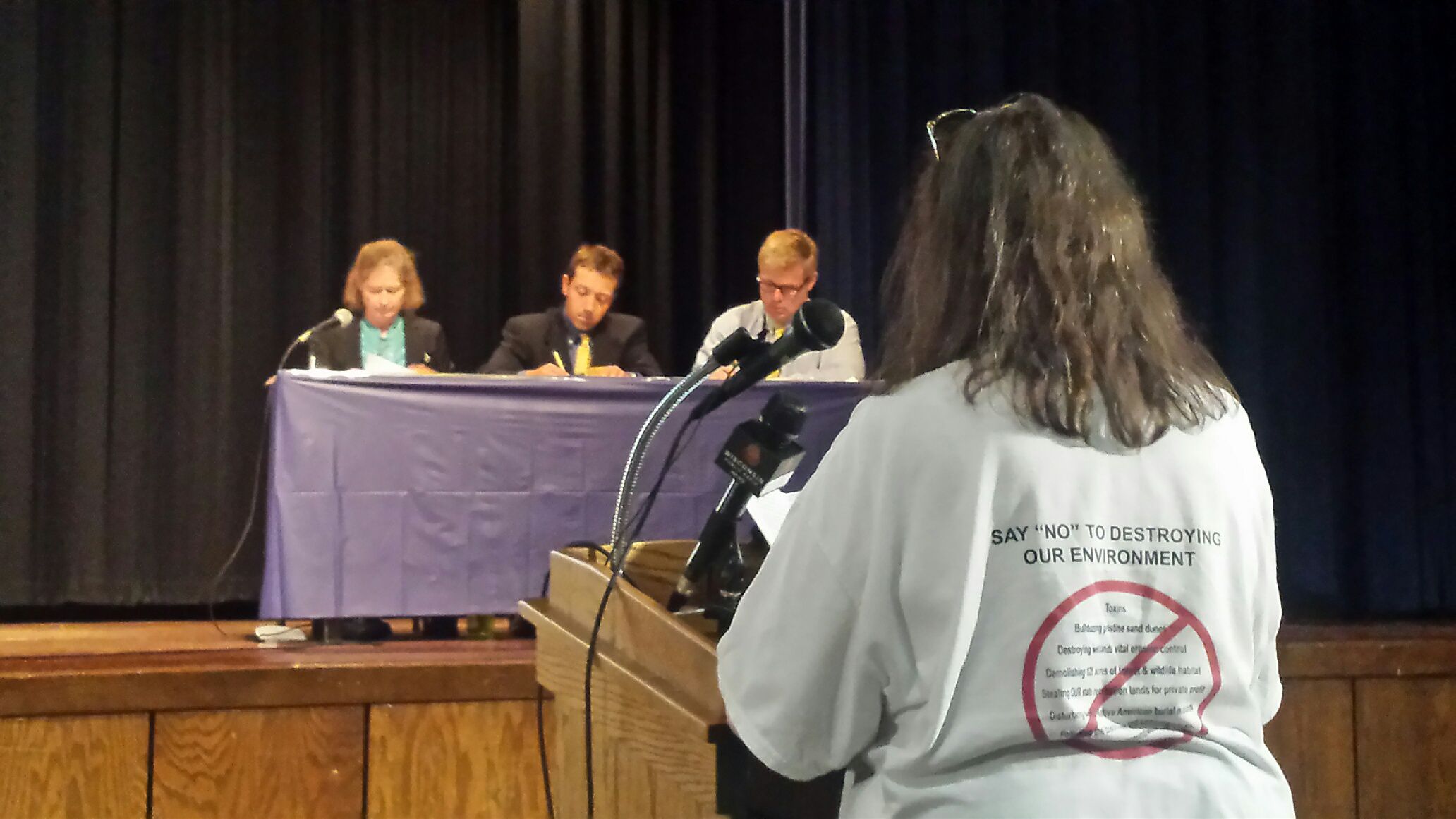 A member of Friends of the Black River Forest (right) testifies at Wednesday night's DNR hearing in Sheboygan Falls.