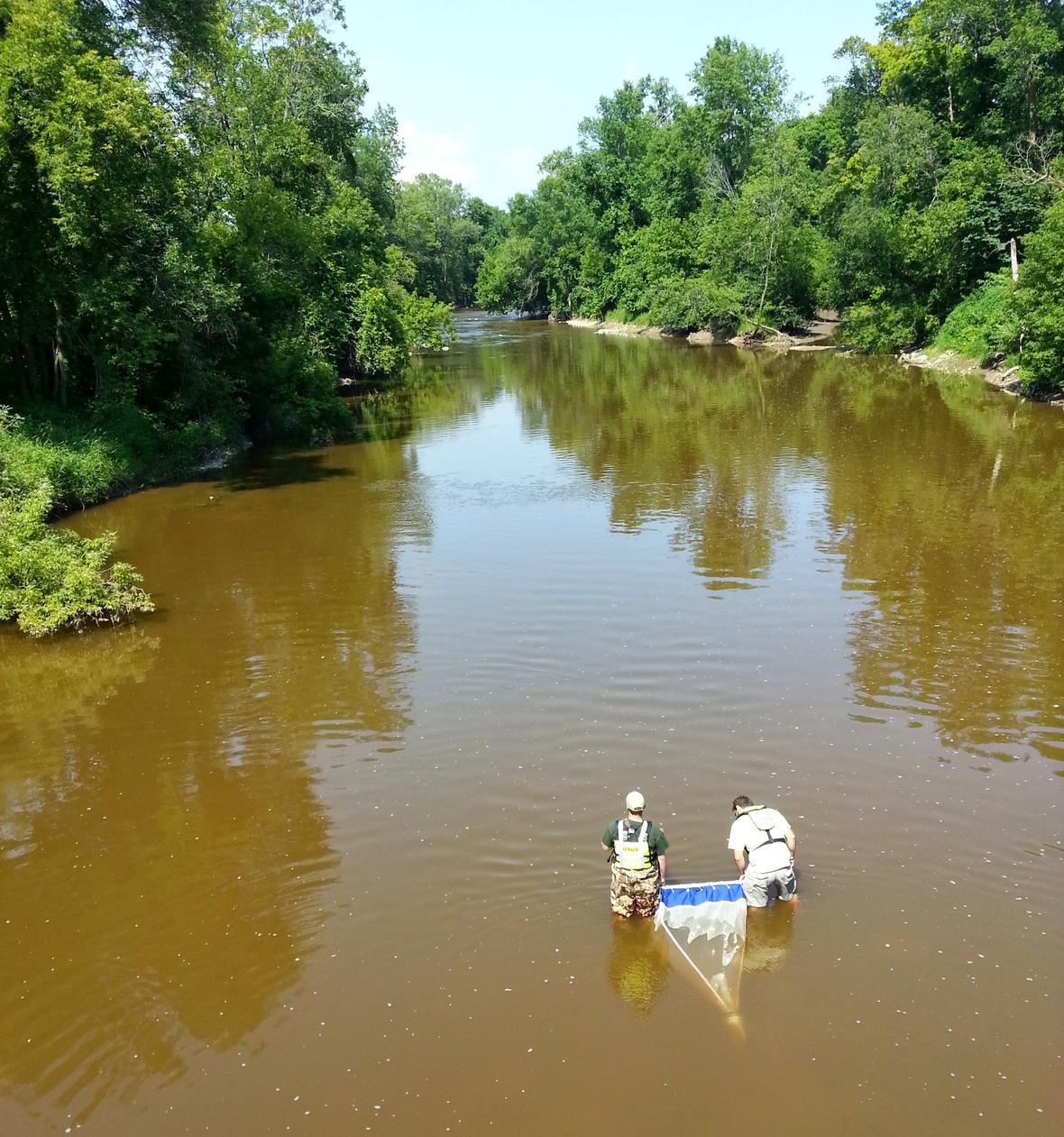 Men collecting microplastic samples in the Manitowoc River