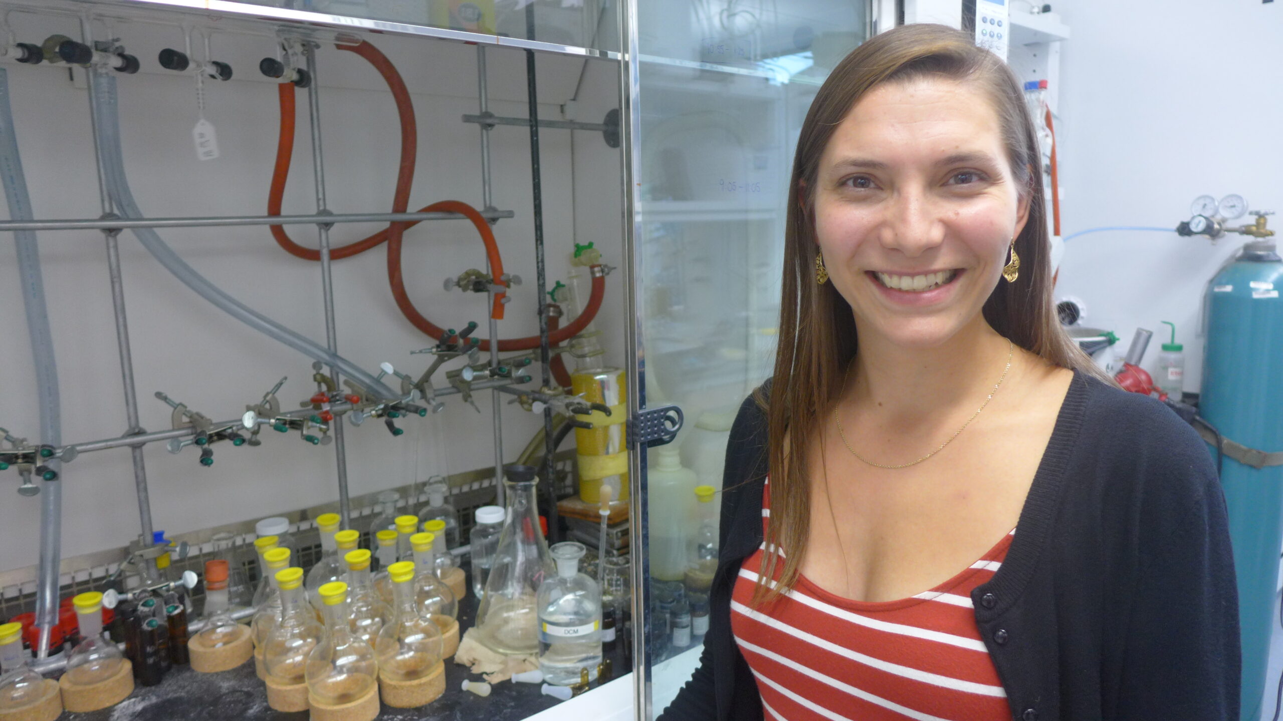 Post-doc researcher Rebecca Smith next to her fume hood