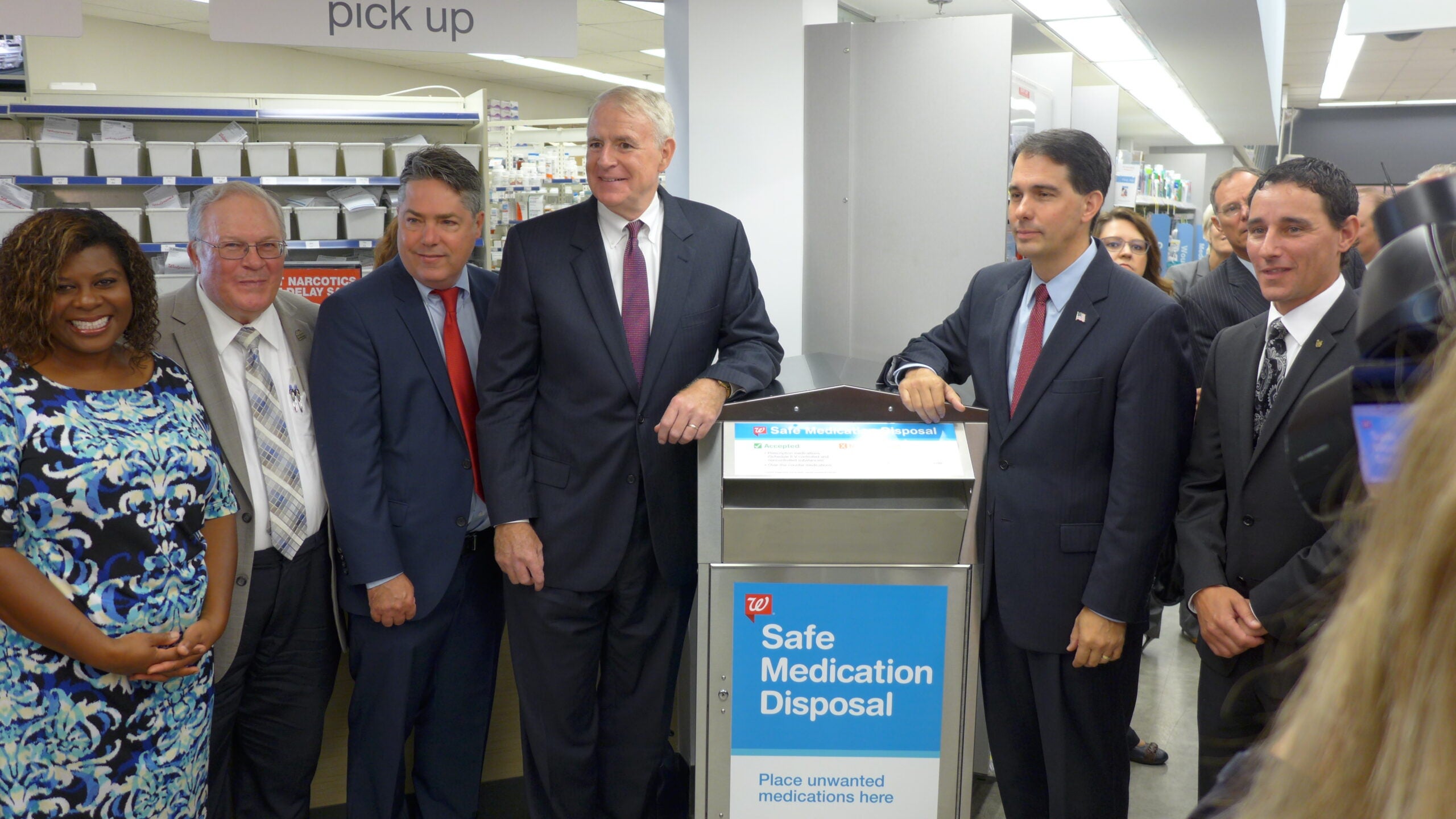 Gov. Scott Walker and Milwaukee Mayor Tom Barrett reveal a new medication drop box at Walgreen's in Milwaukee