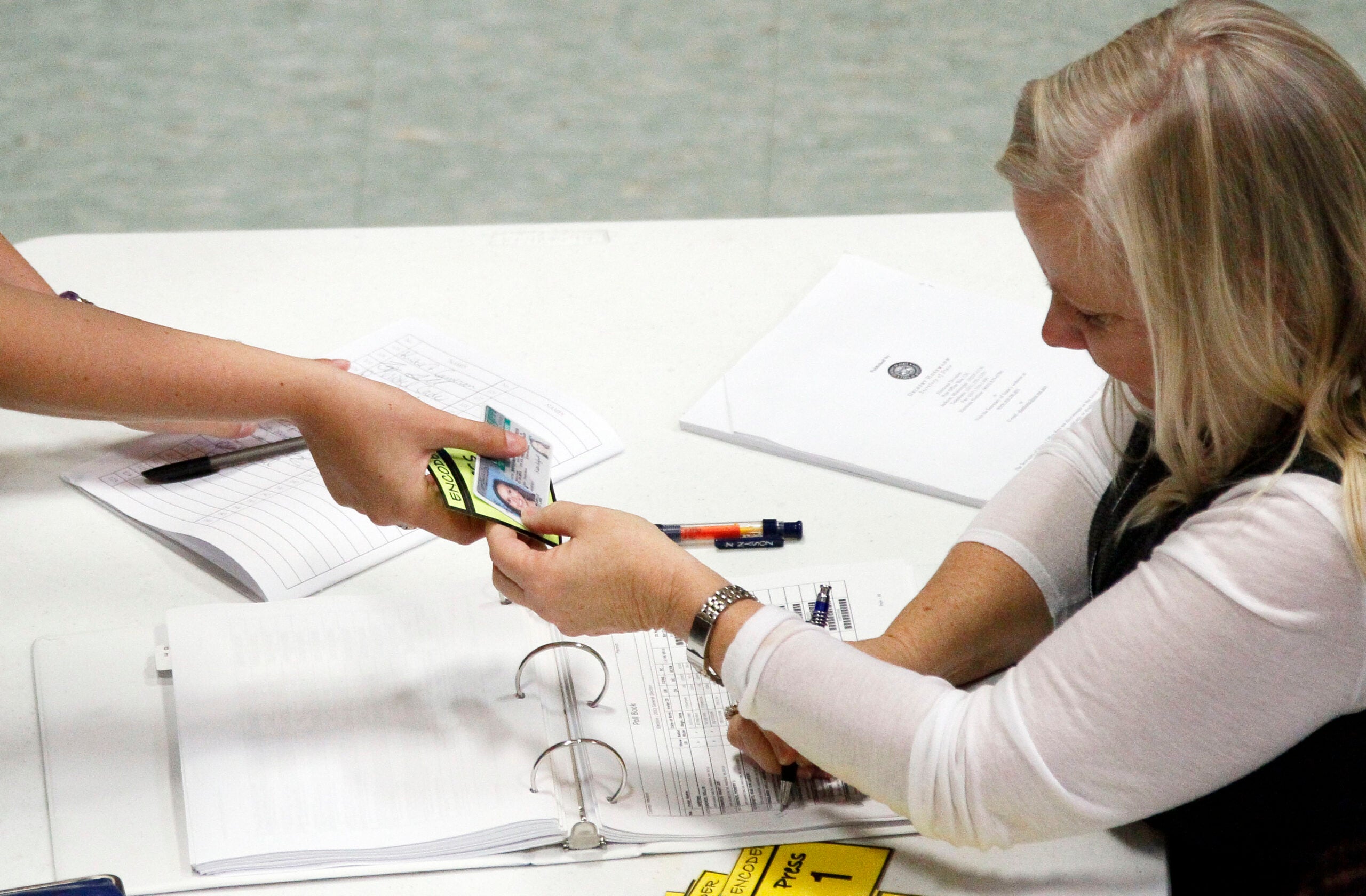 Person showing ID to vote