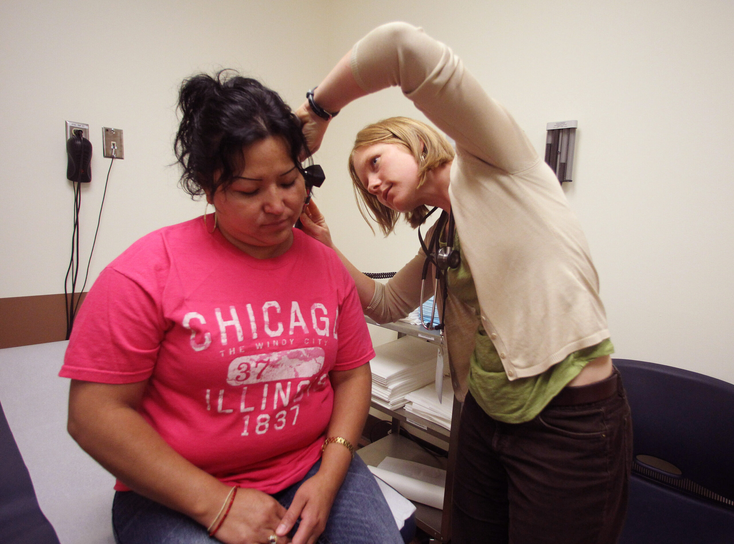 A physician assistant examining a patient