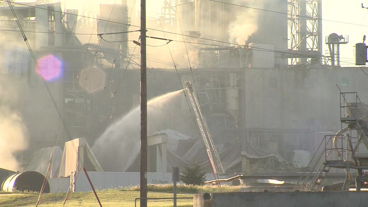 Workers hosing down Didion Milling Plant