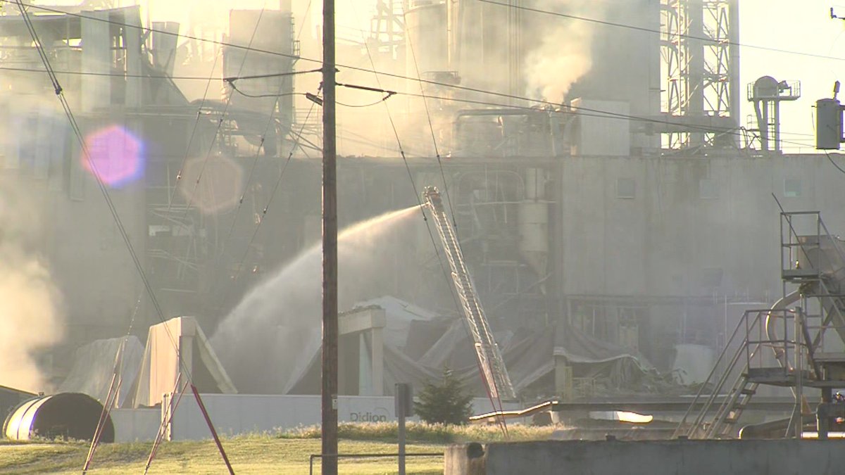 Workers hosing down Didion Milling Plant