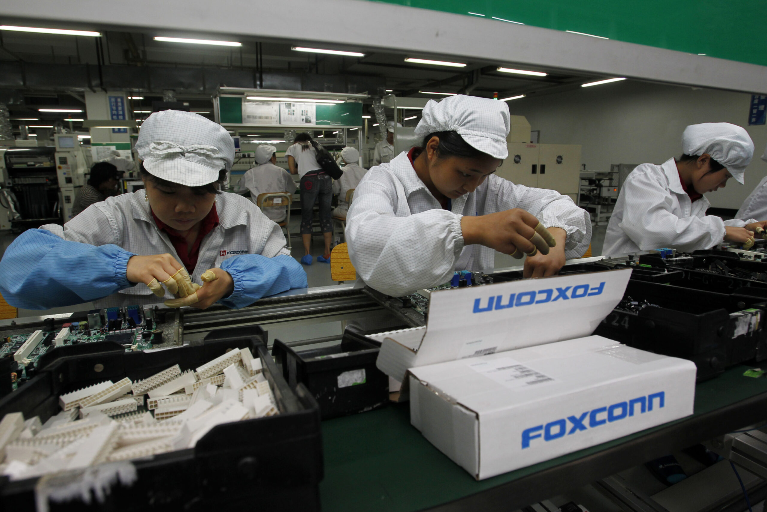 Employees work on the production line at the Foxconn complex in the southern Chinese city of Shenzhen, southern China