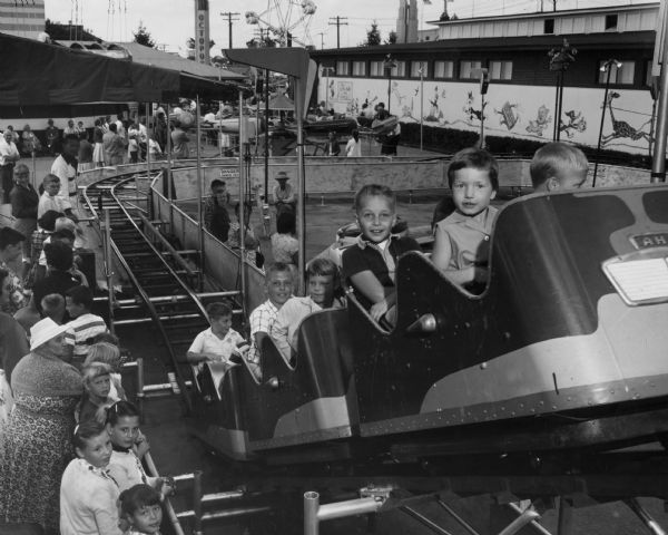 Children riding a roller coaster at the Wisconsin State Fair in West Allis