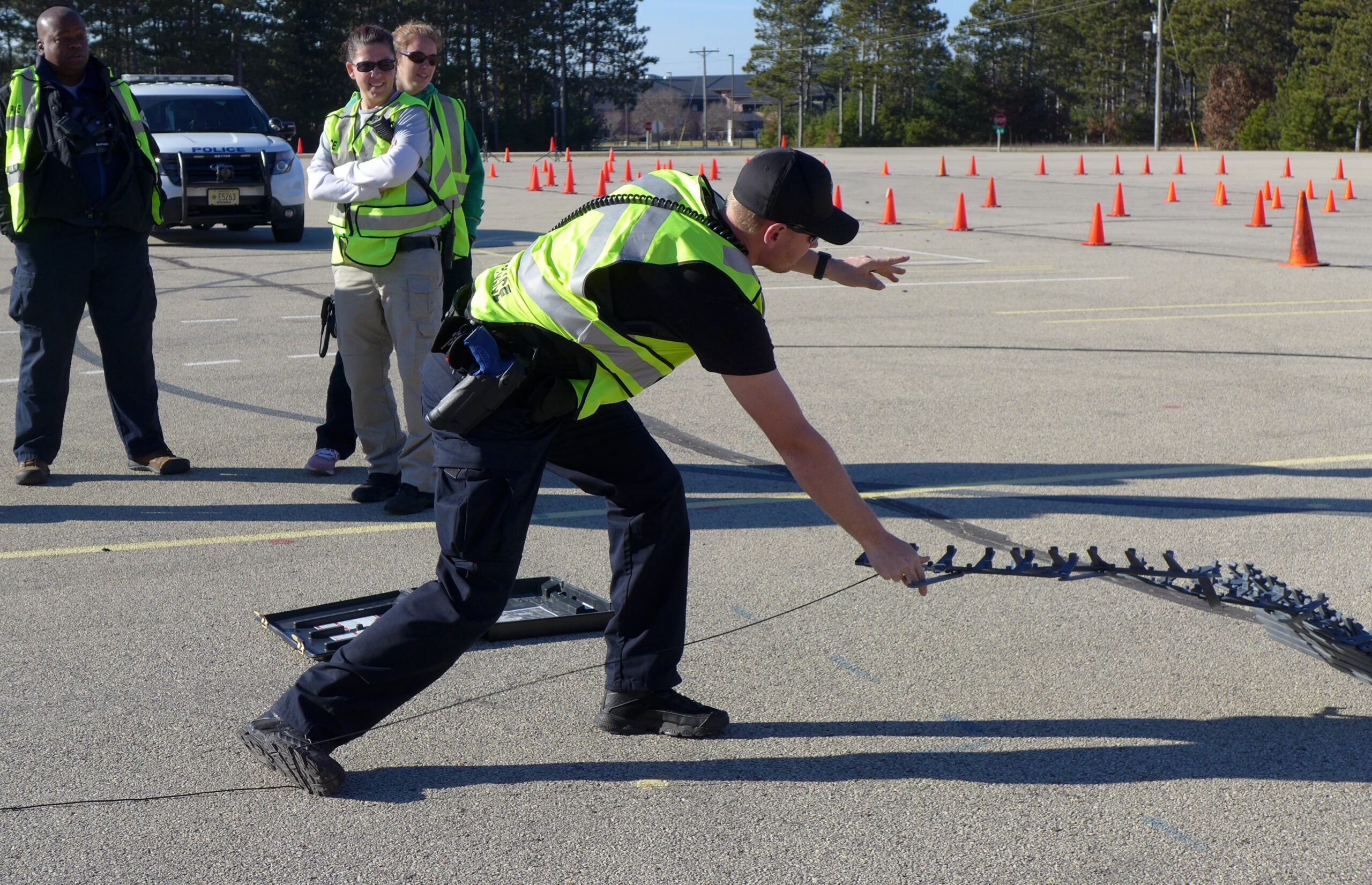 Recruit Nick Pine practices deploying stop strips, which can damage a fleeing vehicle’s tires during a high-speed pursuit.