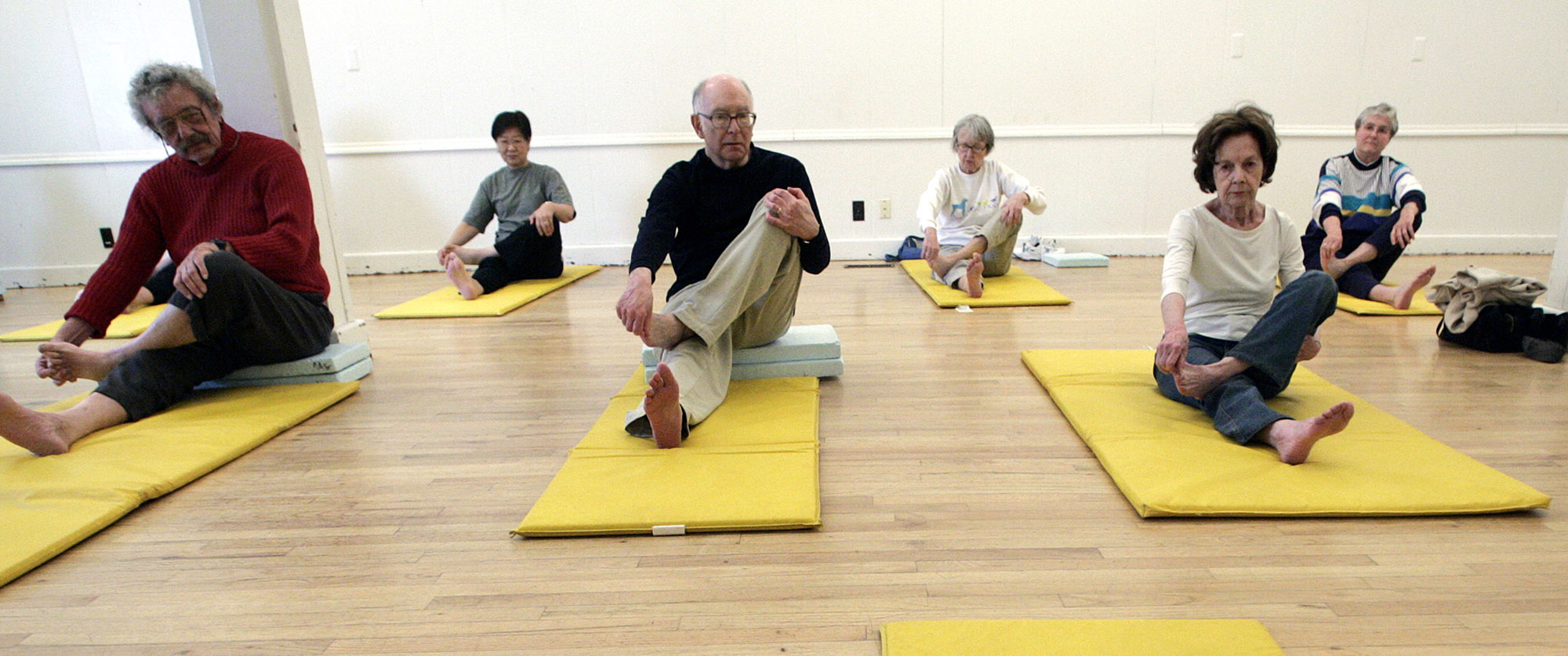 senior citizens practicing yoga