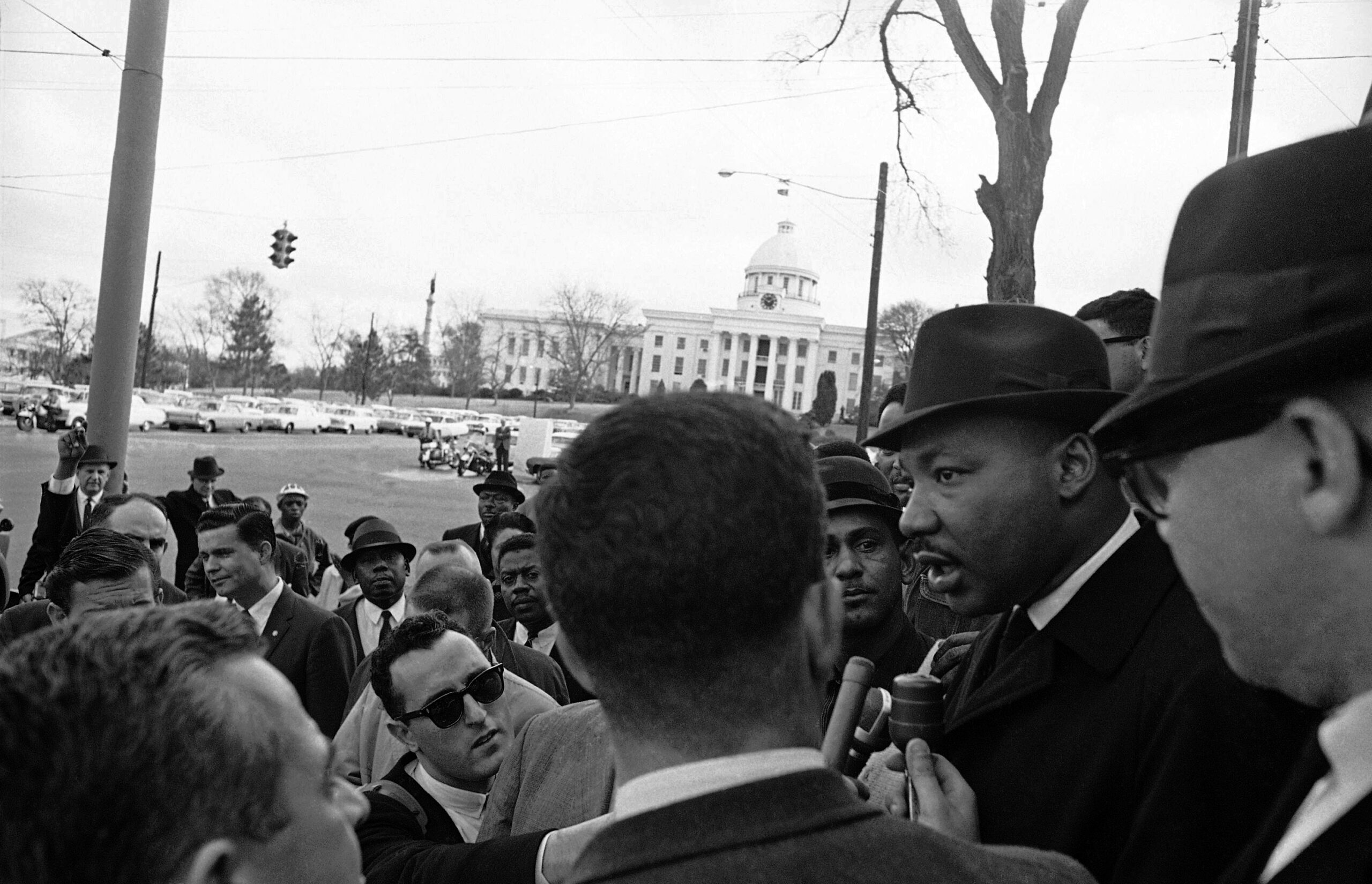 Dr. Martin Luther King Jr. is interviewed on the steps of the Dexter Avenue Baptist Church in Montgomery, Alabama on Feb. 9, 1965, kickoff point for a voter registration march. King had called for 1,000 of his race for the march but only about 200 showed