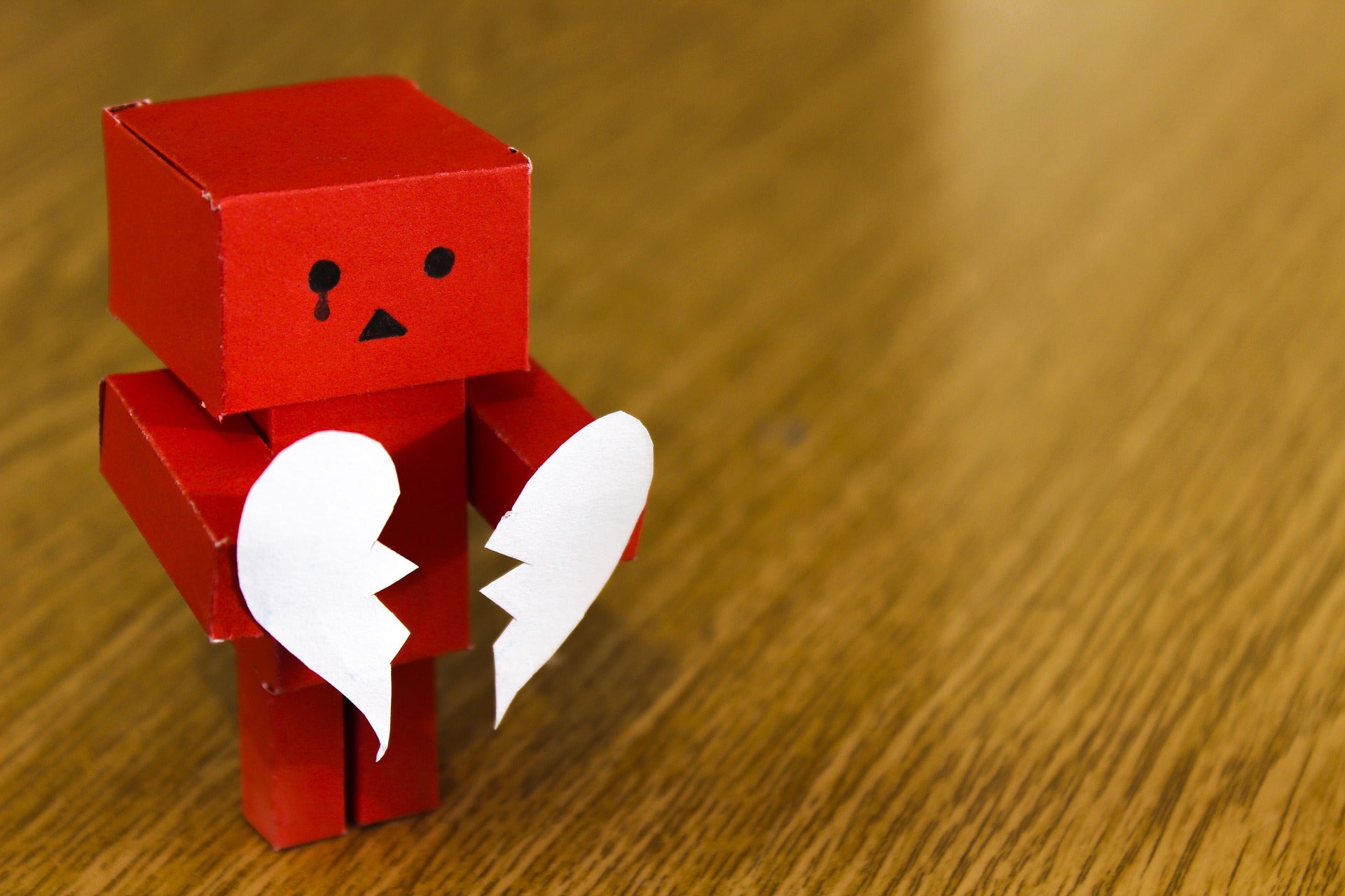 cardboard robot with a broken heart