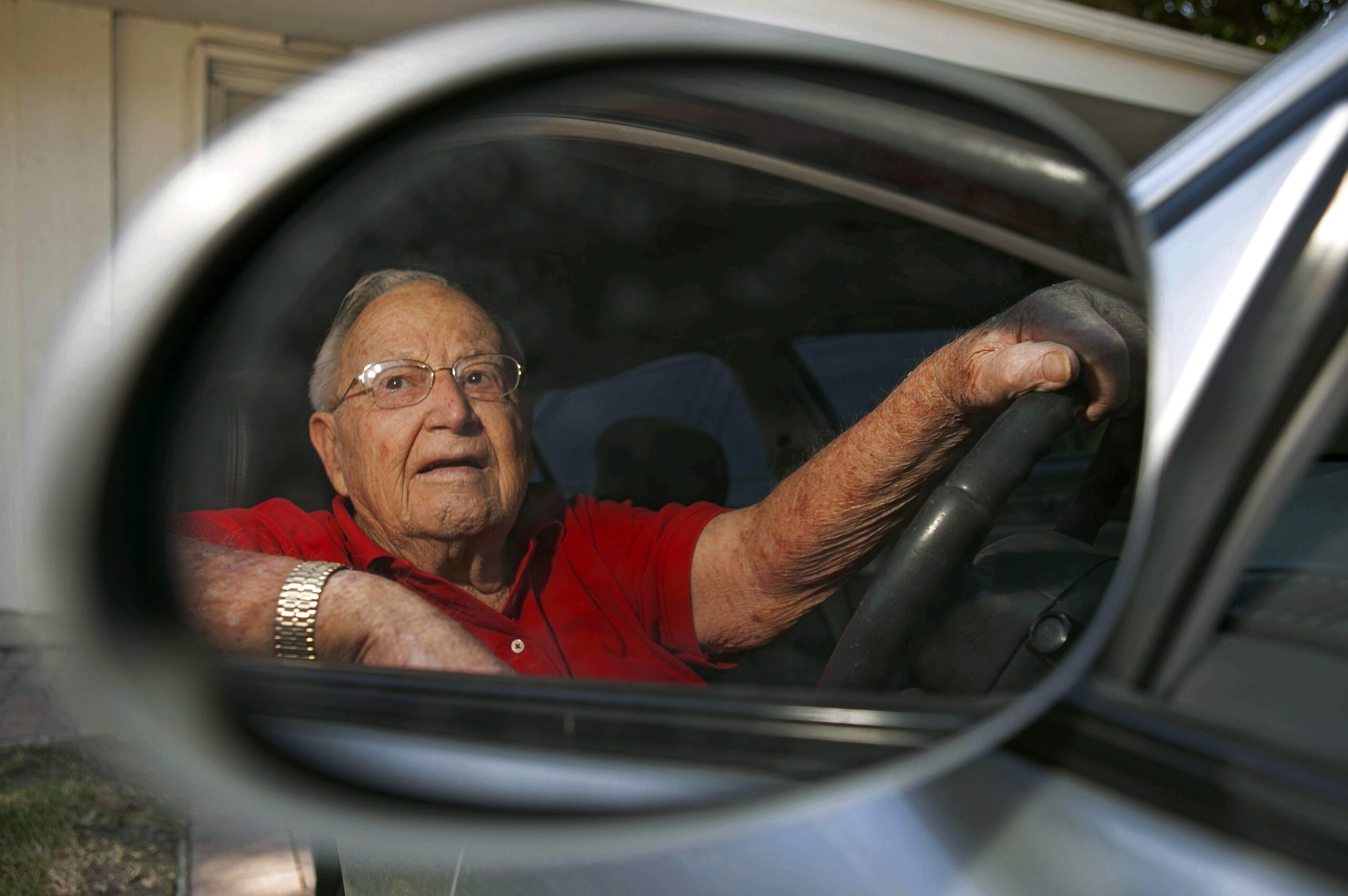 Jack Wyrad, 92, is seen reflected on his side mirrors