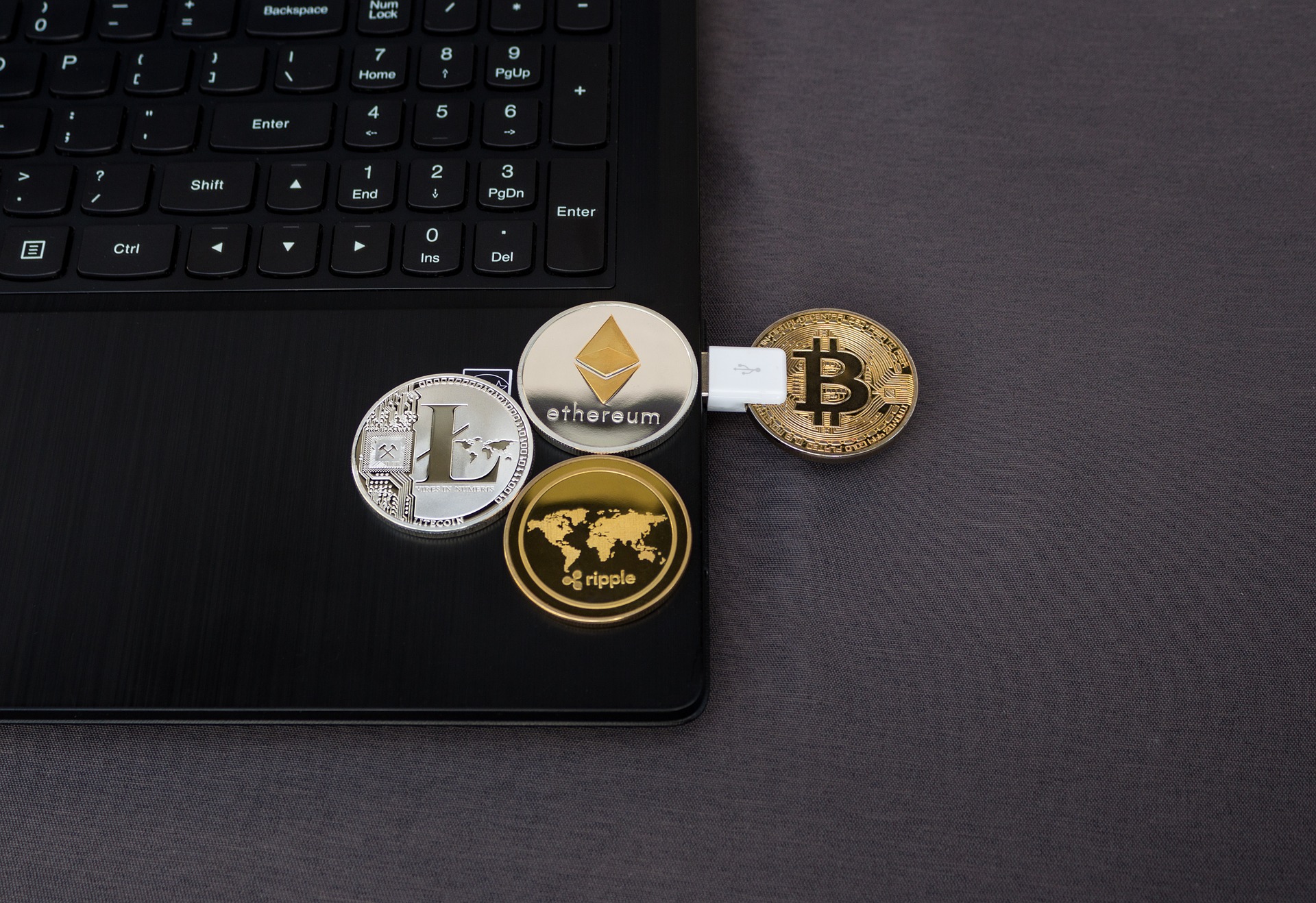 cryptocurrency coins on laptop