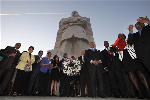 A gathering of officials and dignitaries hold electronic candles during a ceremony at the Martin Luther King, Jr. Memorial, on the 44th anniversary of the assassination of Dr. Martin Luther King, Jr. in Washington, on Wednesday, April 4, 2012.