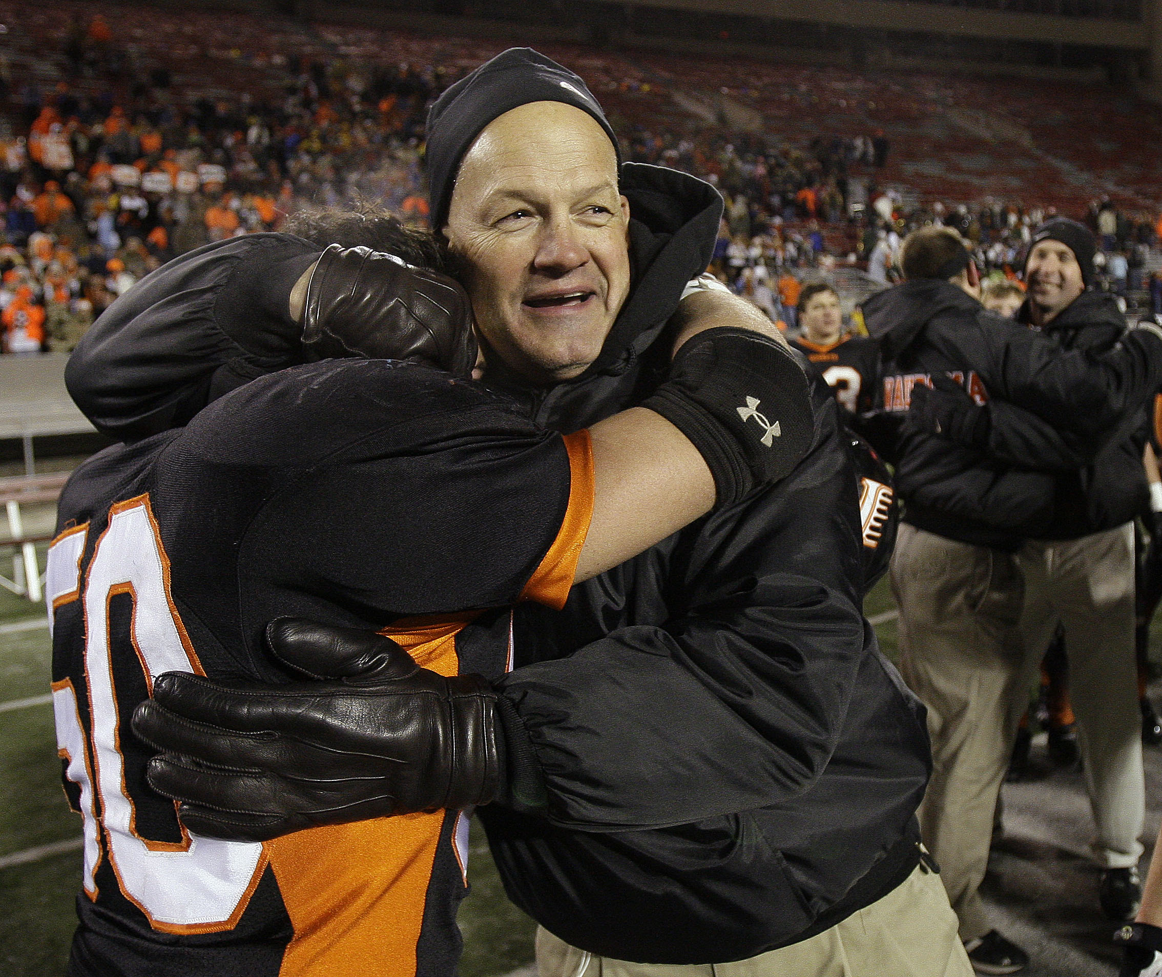Wautoma/Faith Christian coach Dennis Moon hugs Garrett Bickford (50) after the WIAA Division 4 high school football championship game