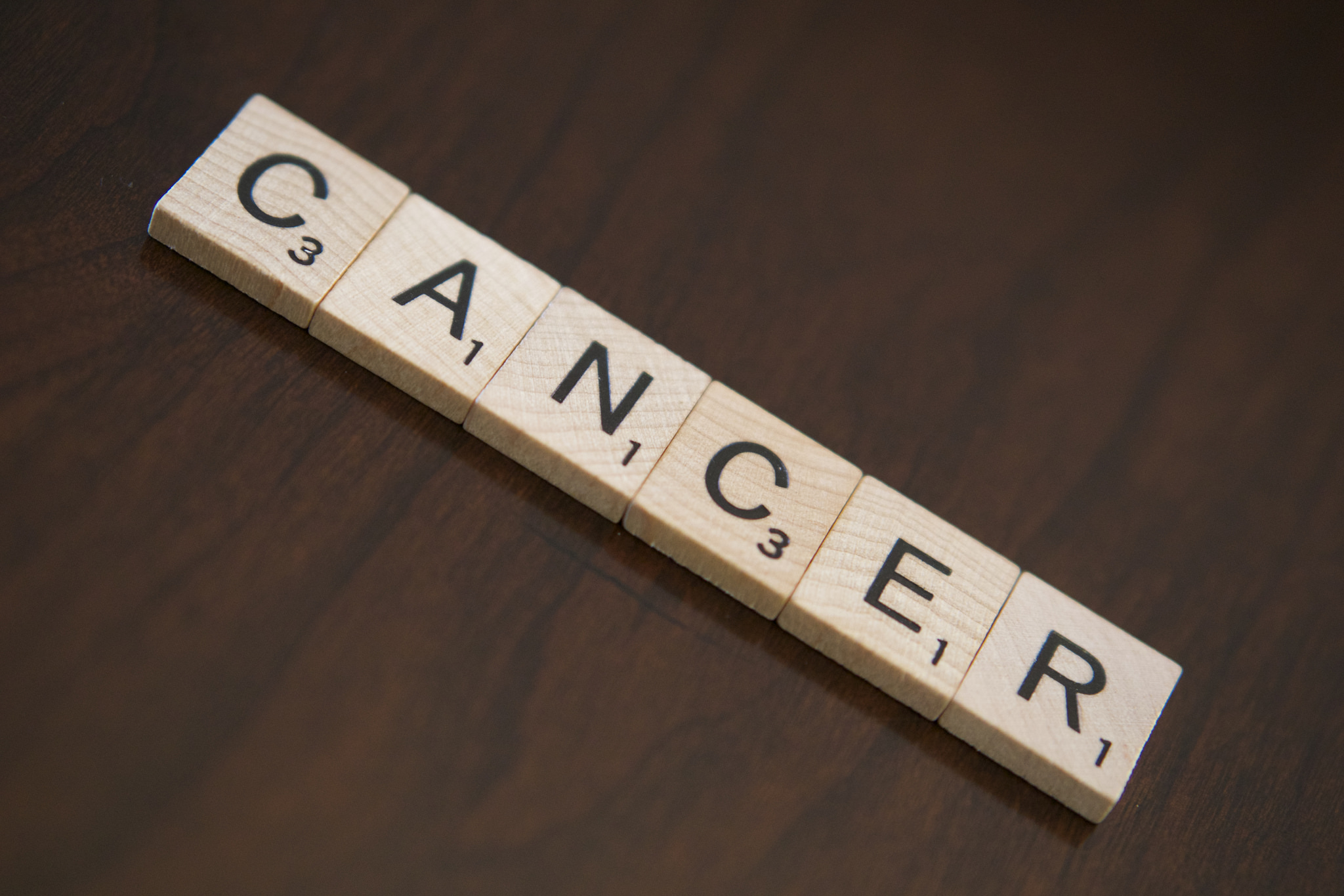 Cancer spelled with scrabble tiles