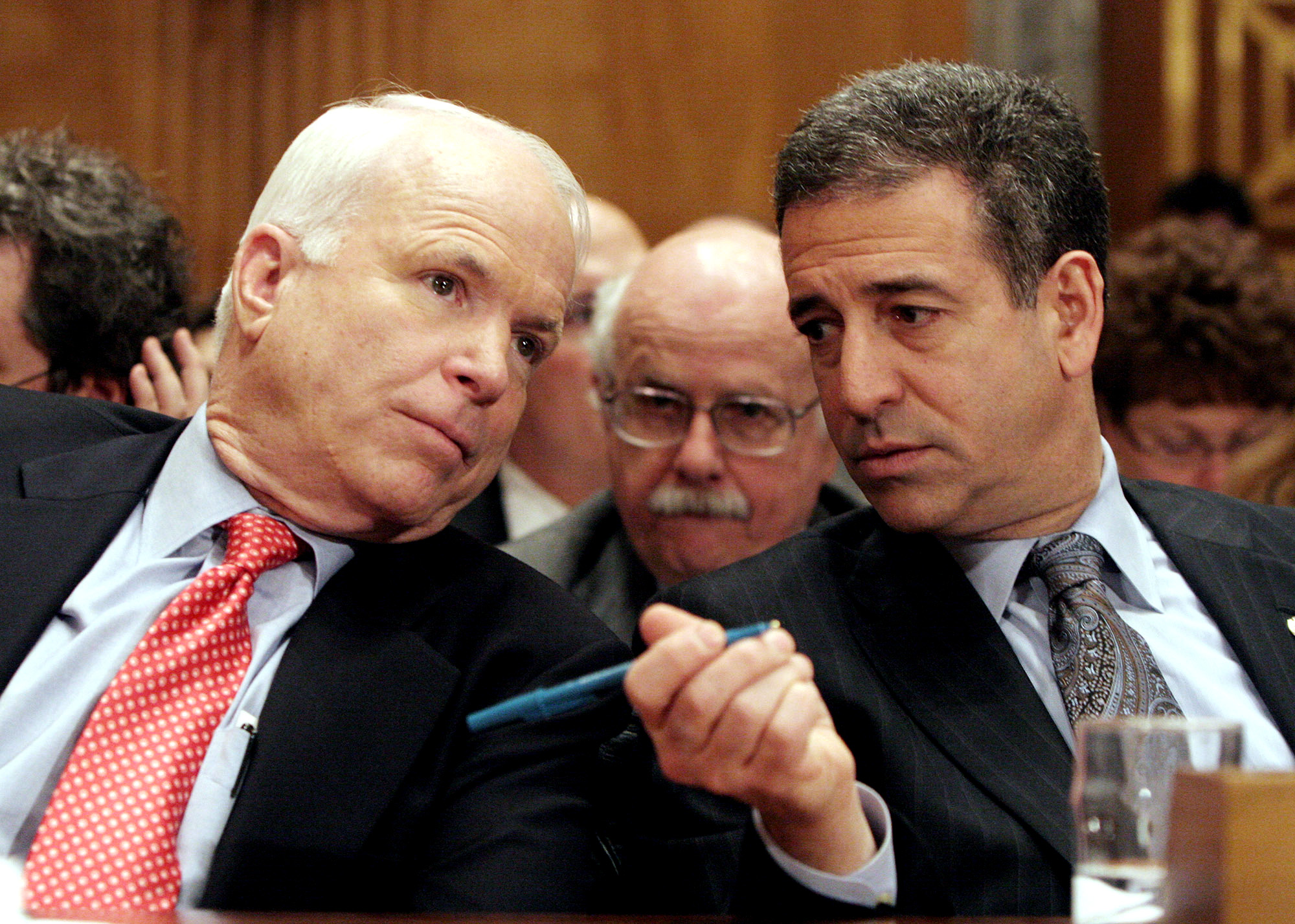 Sen. John McCain chats with Sen. Russ Feingold on Capitol Hill
