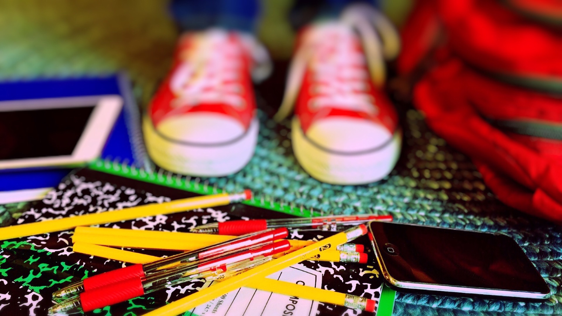 child's feet with school supplies on floor