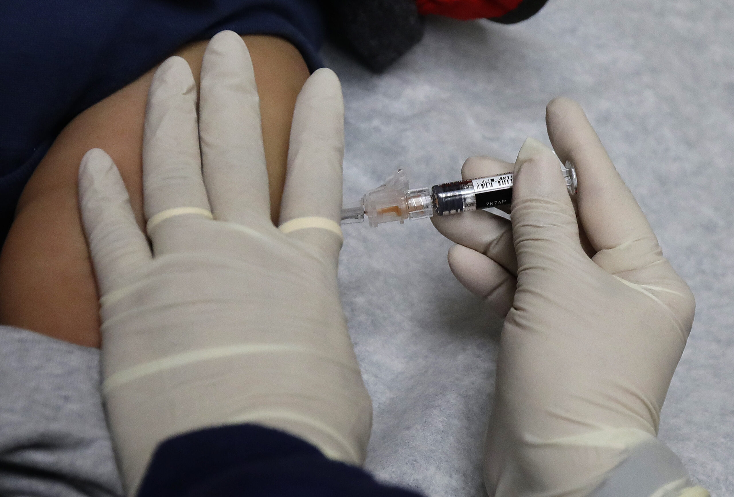 medical assistant gives a patient a flu shot