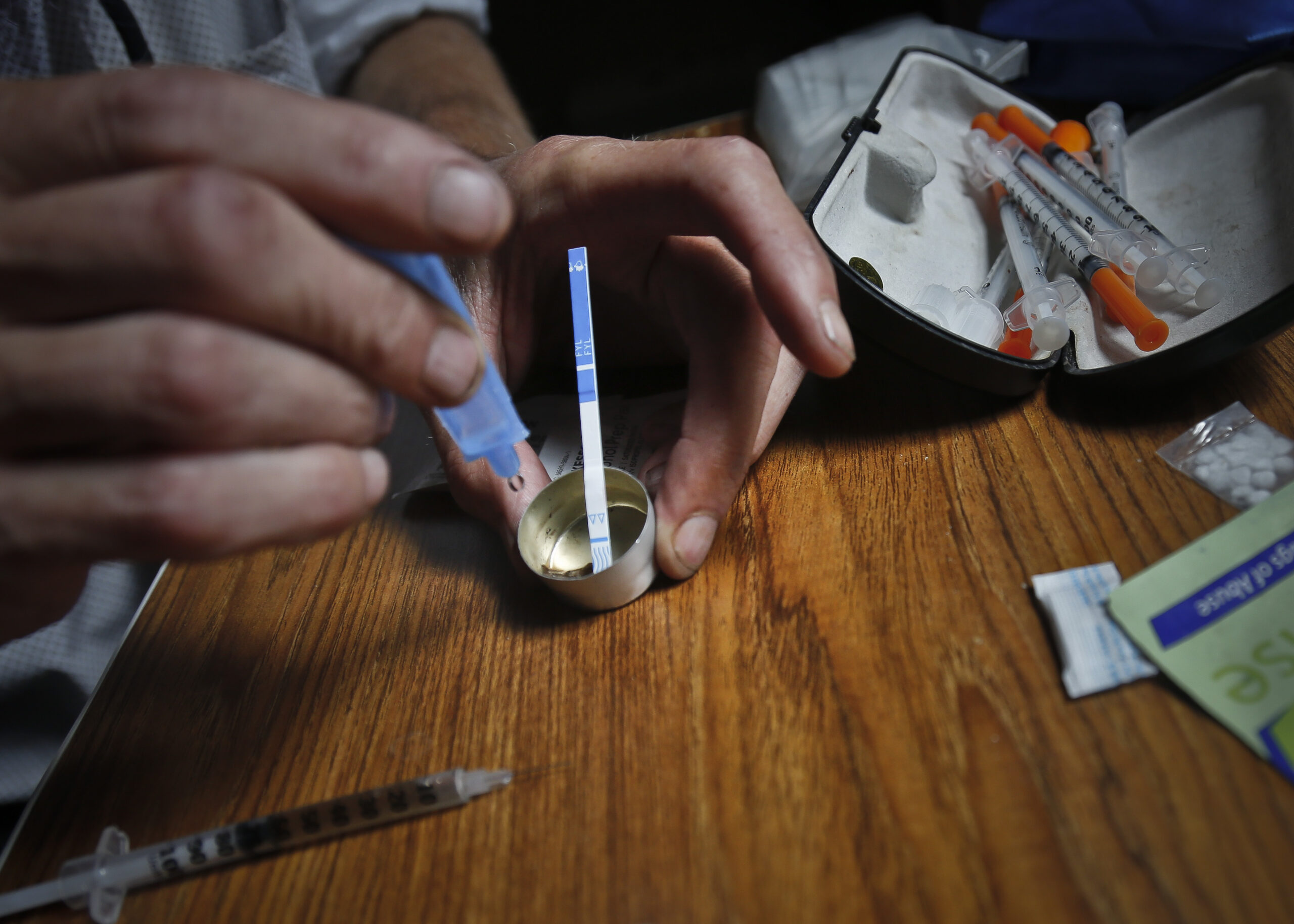An addict prepares heroin