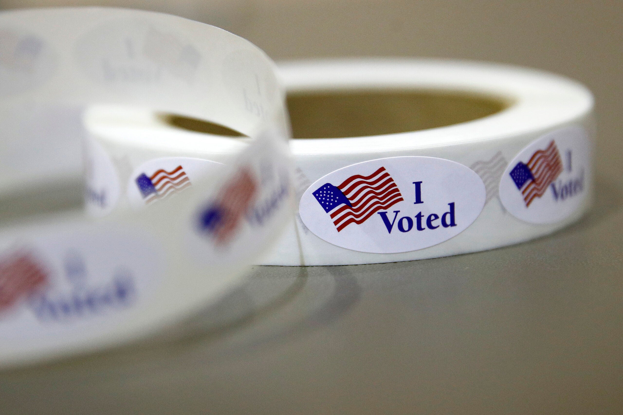 I voted stickers sit on a table at a polling place,