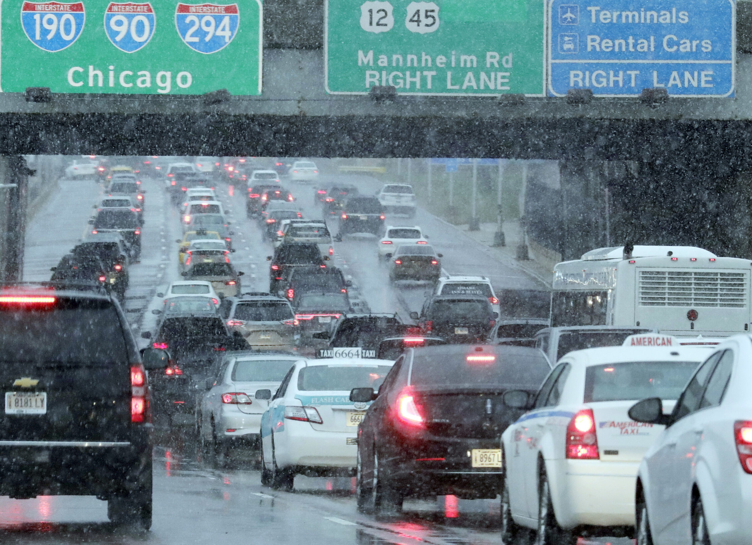 Heavy traffic is seen on Interstate 190 near due to a winter snow storm