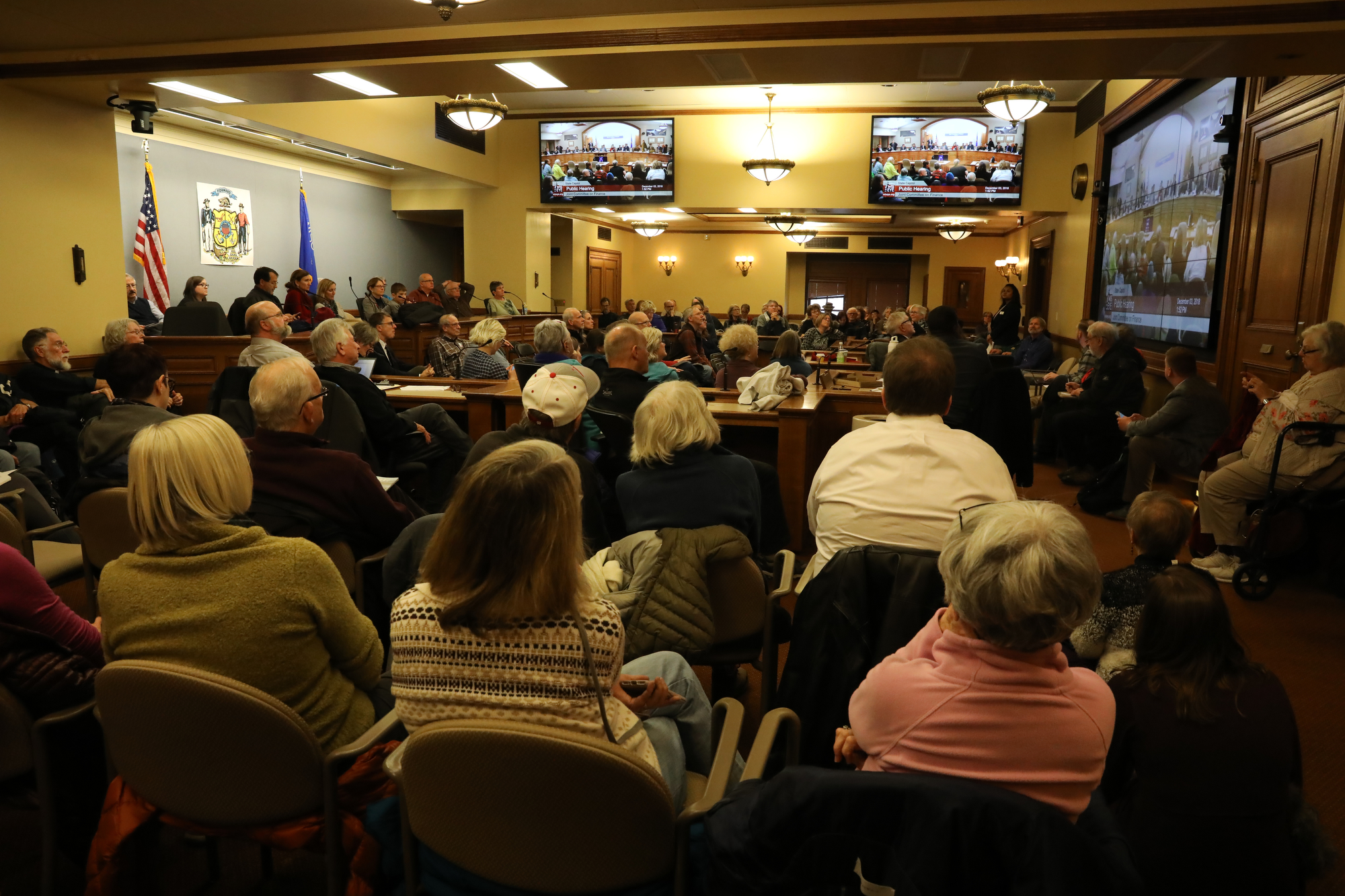Members of the public occupy an overflow room during the Joint Finance Committee public hearing