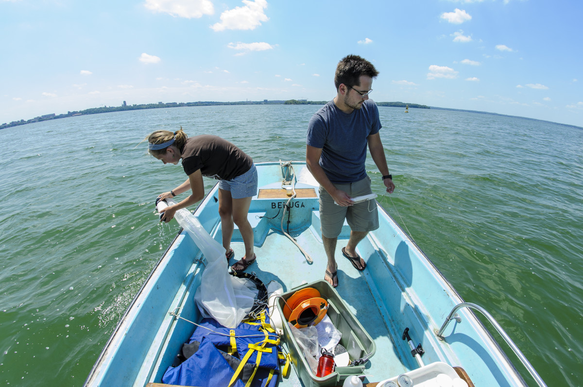 Jake Walsh and an undergraduate student use zooplankton nets to collect water samples from Lake Mendota in 2012