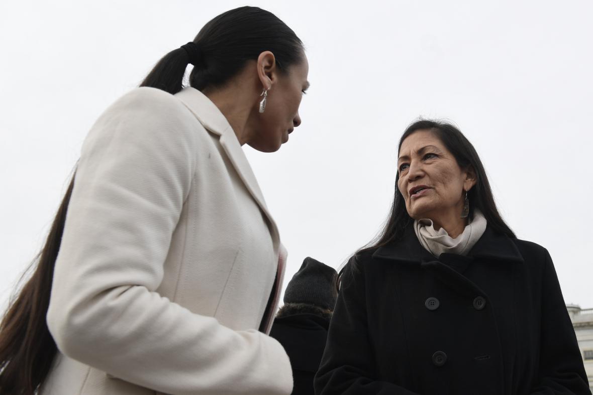 Rep. Deb Haaland, D-N.M., right, talks with Rep. Sharice Davids, D-Kan., left, as they arrive for a group photo