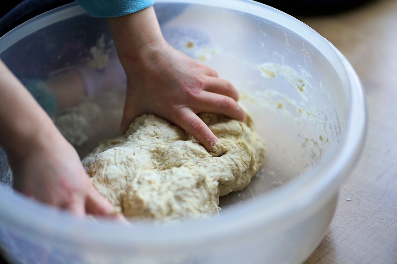 Kneading bread dough in a bowl