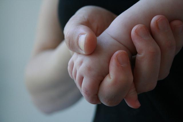 Mom holding baby's hand