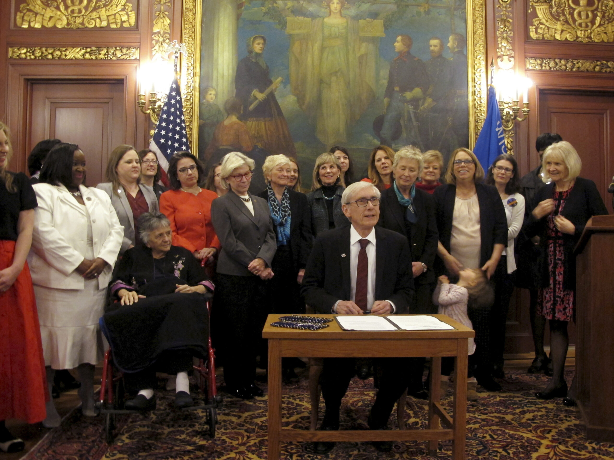 Gov. Tony Evers is surrounded by some of the most powerful women