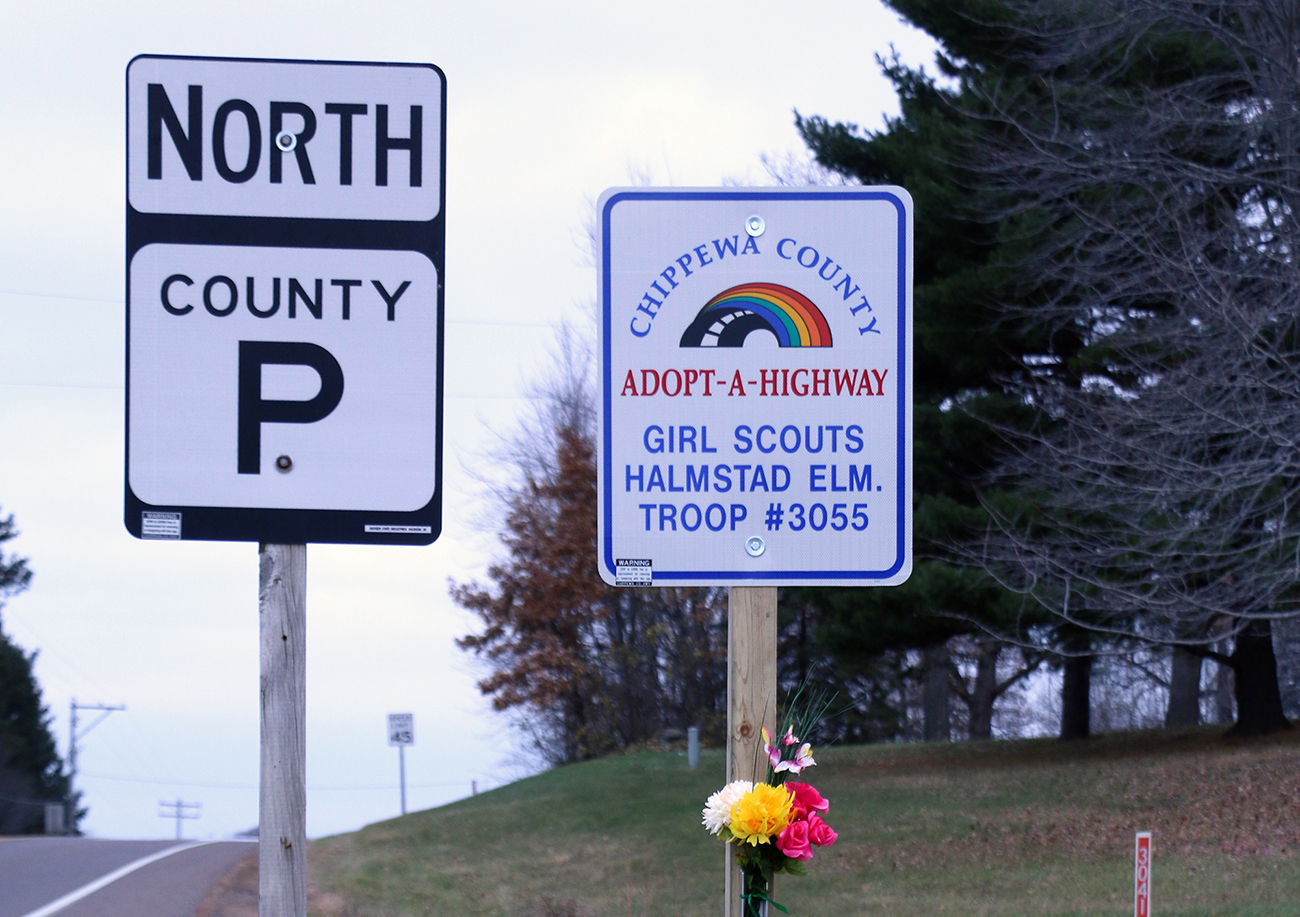 Adopt-A-Highway sign listing the Girl Scout troop that was struck