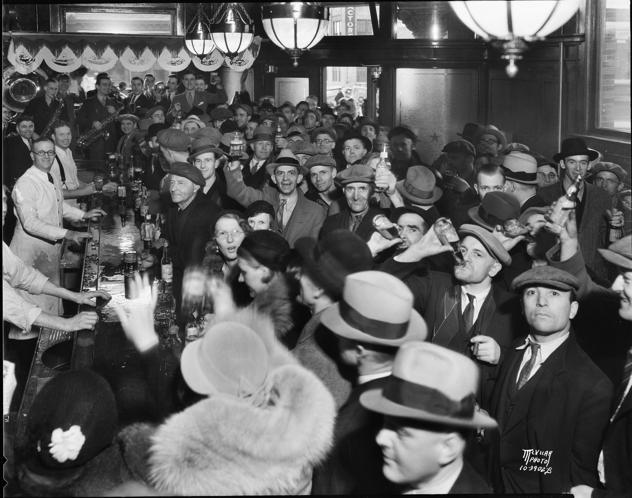 crowd of men and women drinking celebrating the end of Prohibition
