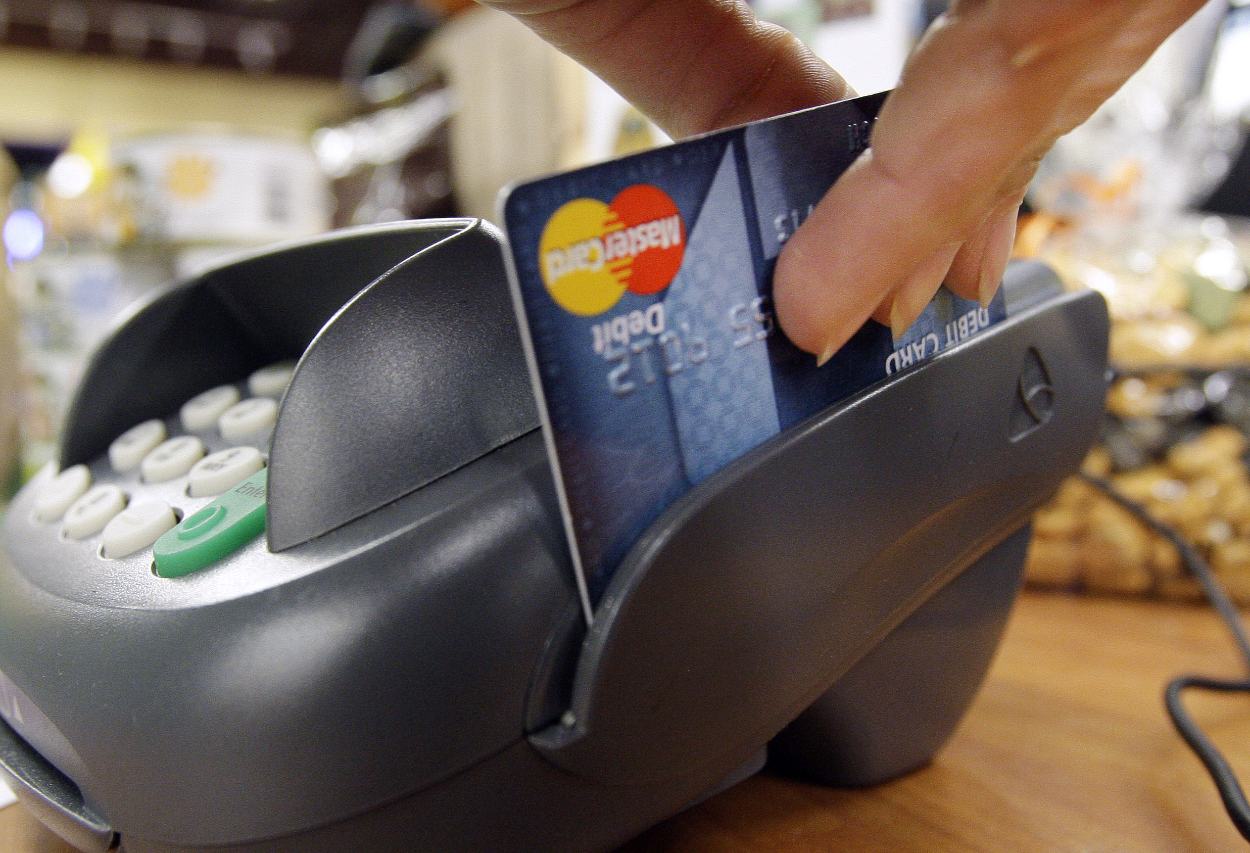 A debit card being swiped