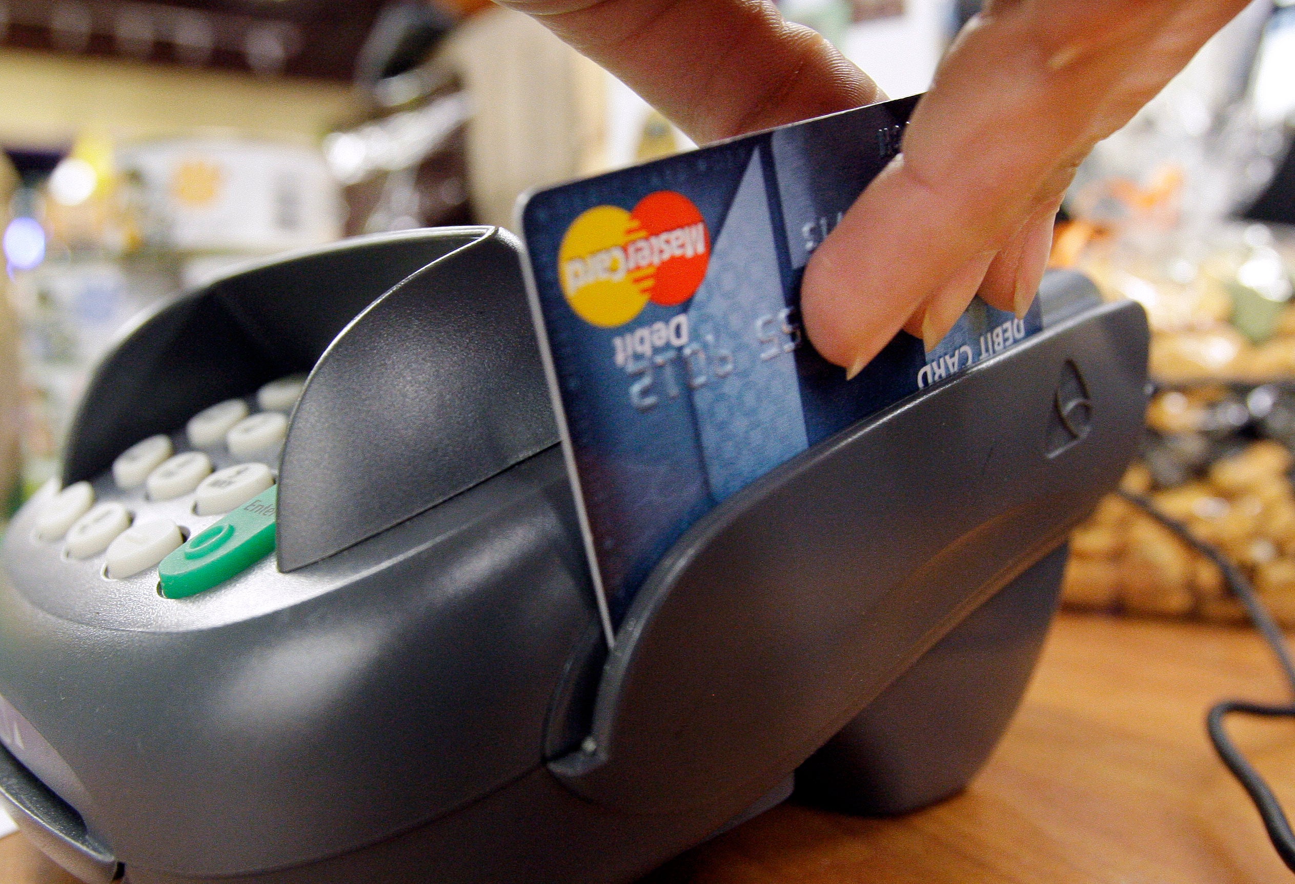 A debit card being swiped