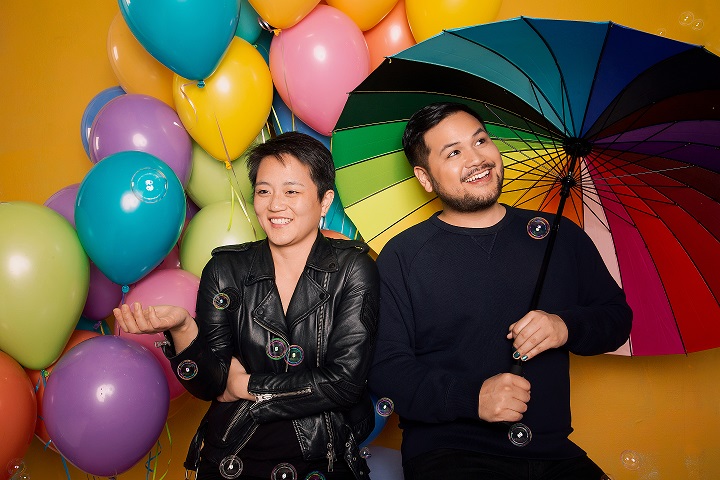 Tobin Low and Kathy Tu with balloons and umbrellas
