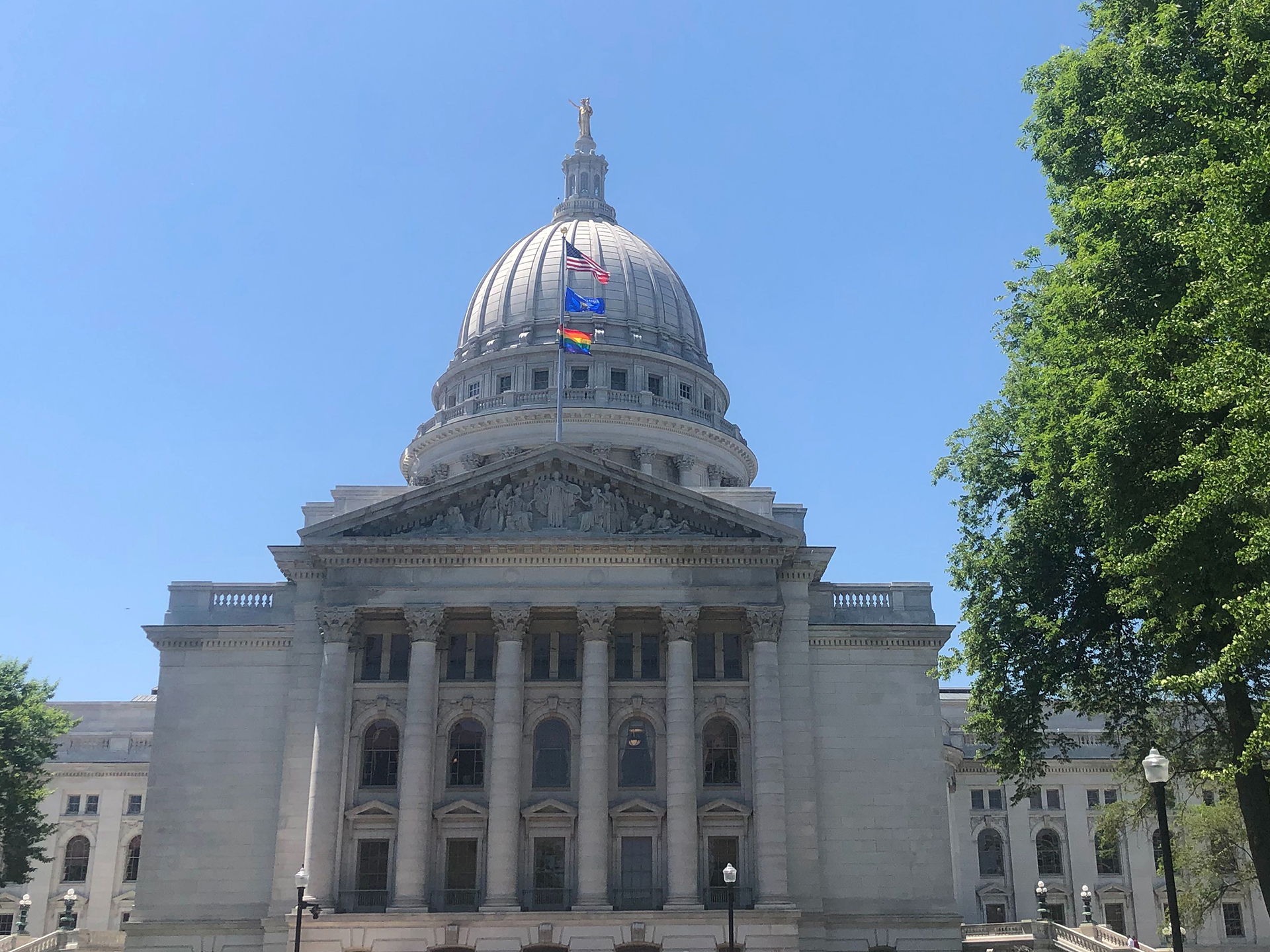 a rainbow flag flies over the state Capitol in recognition of "Pride Month"