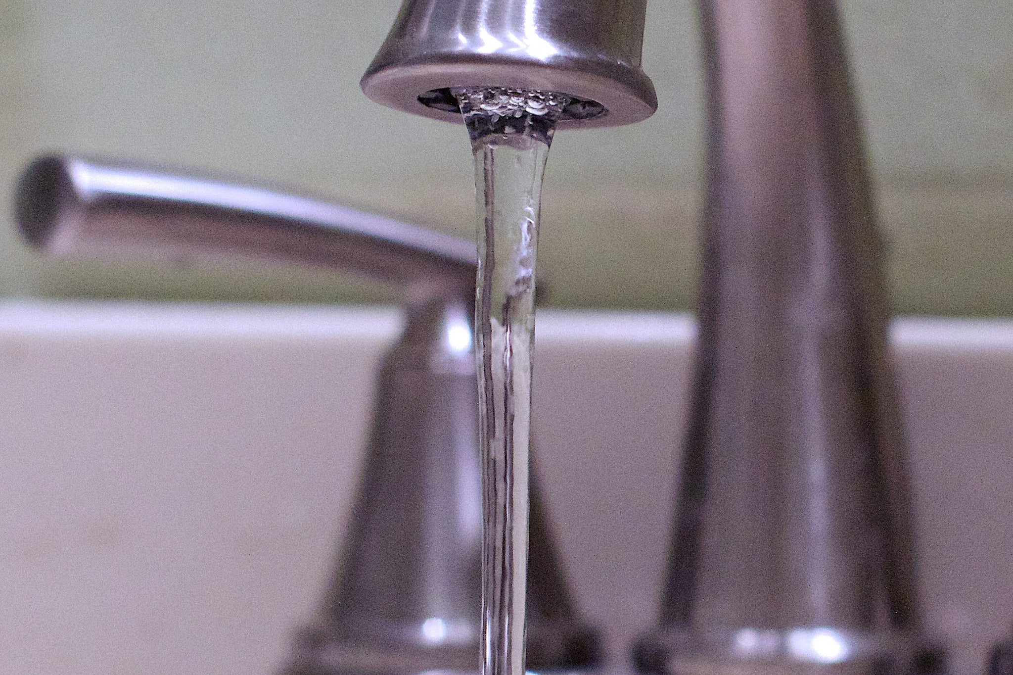 Water comes out of a faucet