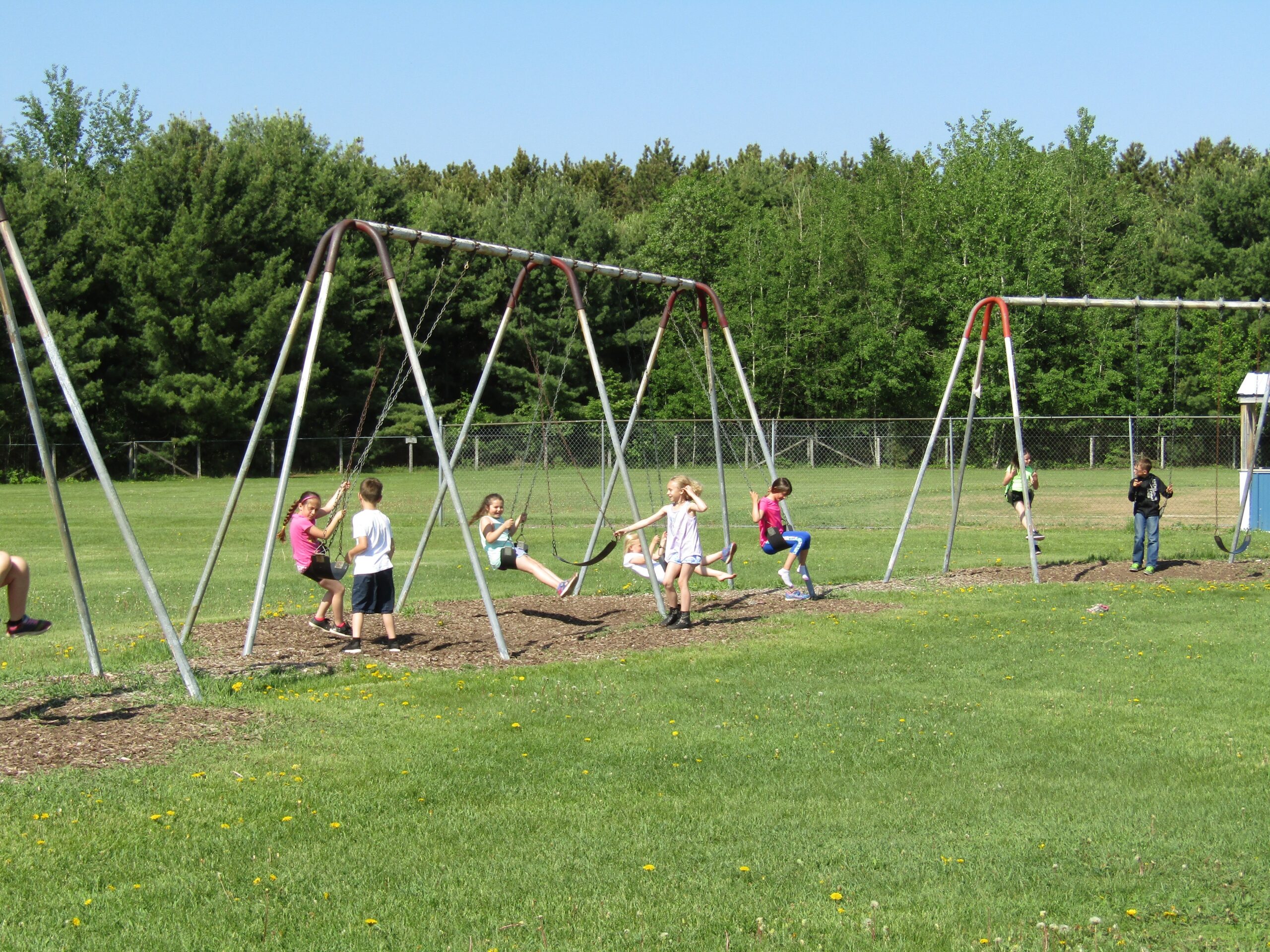 Students swing during recess at Langlade County’s Pleasant View Elementary School